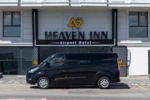 a black van parked in front of a hotel at Heaven Inn Airport Hotel in Arnavutköy