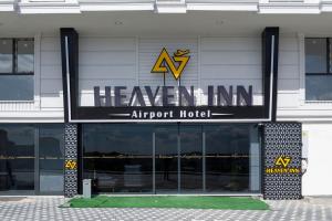 a building with a sign for aaven inn airport hotel at Heaven Inn Airport Hotel in Arnavutköy