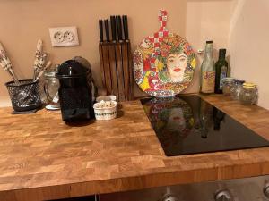 a counter top with a plate and bottles on it at Annabella’s place in Veliko Tŭrnovo