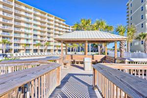 a boardwalk with benches and a gazebo and a building at Seaside Beach and Racquet Club Condos II in Orange Beach