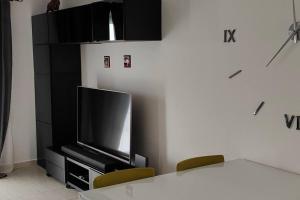 a flat screen tv sitting on a black entertainment center at Acogedor Apartamento Residencial in Costa Teguise