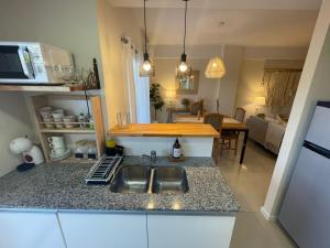 a kitchen with a sink and a counter top at PASO SQUARE in La Plata