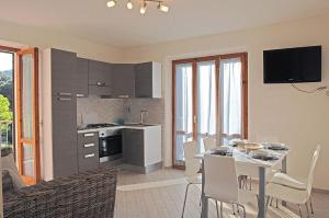 a kitchen and dining room with a table and chairs at Appartamenti Casa Pineta in Marina di Campo