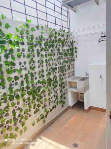a bathroom with a wall covered in plants at FLAWLESS LODGE EN IMBANACO, Cali-Colombia in Cali
