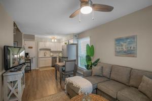 a living room with a couch and a kitchen at The Cove 205B by Vacation Homes Collection in Gulf Shores