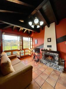 a living room with a couch and a fireplace at Apartamentos Turisticos Paseo de la Alameda in Villaviciosa