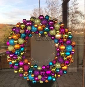 a wreath of christmas ornaments on a window at Illaberek Turistaház in Sukoró