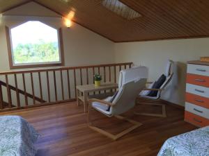 a room with two chairs and a table and a window at CASA EL ROSEDAL en Ortigueira in Santa Marta de Ortigueira