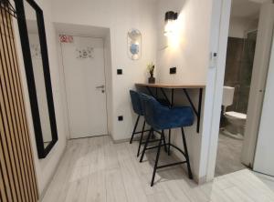a small bathroom with a desk and a blue chair at Alegra Apartments Center in Rijeka