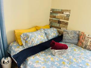 a bed with a blanket and pillows on it at Nouvelle Orange Willemstad in Willemstad