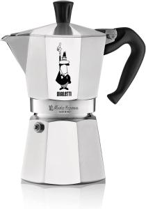 a white coffee maker with a witch on it at La Feriolina - Appartamento al lago con giardino privato in Baveno