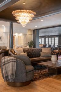 a living room with a couch and a chandelier at The Wentworth in Jackson