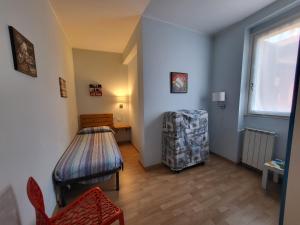 a room with a table and a chair and a window at Red Apartment - Residenza Silvana in Verbania