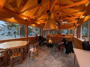 a group of people sitting at tables in a room with windows at Eagle's Eye Vacation Rentals in Sterling