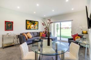 a living room with a couch and a glass table at Golf Haven with Pool Access - 5 Mi to Palm Springs in Cathedral City