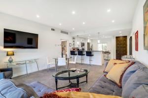 a living room with a couch and a table at Golf Haven with Pool Access - 5 Mi to Palm Springs in Cathedral City