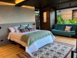 a bedroom with a large bed and a couch at Cumbres Luxury Glamping in Guarne