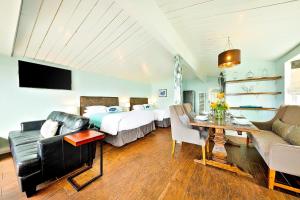 a bedroom with a bed and a living room at OB Pier 2 in San Diego