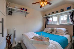 a bedroom with a bed and a ceiling fan at OB Beach Daze 2 in San Diego