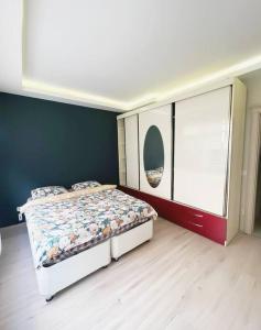 a bedroom with a bed and a large window at House in the center of Kadikoy in Istanbul