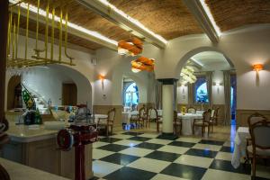 a restaurant with a checkered floor and tables and chairs at Villa Ariston in Opatija