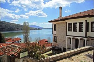 a building with a view of a lake and a house at Vergoula's Mansion in Kastoria