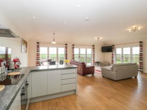 an open kitchen and living room with a couch at Rectory Farm View in Queen Camel