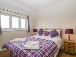 a bedroom with a bed with two towels on it at Rectory Farm View in Queen Camel