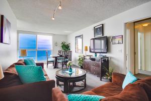 a living room with a couch and a tv at Beachview Condo in San Diego