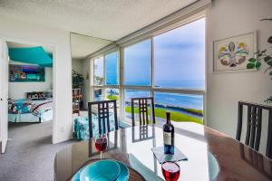 a dining room with a table with a glass of wine at Beachview Condo in San Diego