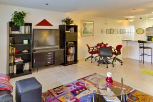 a living room with a table and a dining room at Pool View Condo in San Diego