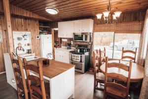 a kitchen with a table and chairs in a house at Cozy lake cottage in Wabamun
