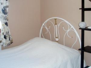 a white bed with a white headboard in a room at Four-Bedroom Holiday home in Dalarö in Dalarö