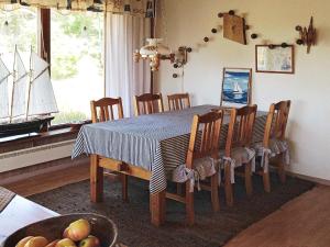 a dining room table with a blue and white table cloth at Four-Bedroom Holiday home in Dalarö in Dalarö