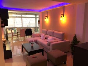 a living room with a couch and a purple light at Apartamento amplio y céntrico in Fuengirola