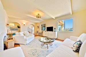 uma sala de estar com dois sofás brancos e uma mesa em On The Beach Casa em San Diego