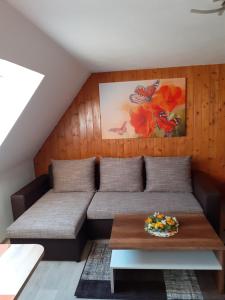 sala de estar con sofá y mesa en Ferienwohnung-Ritscher-in-Lichtenhain-2, en Lichtenhain