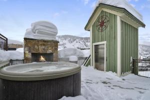 a building with a hot tub in the snow at The Pearl of Park City in Park City