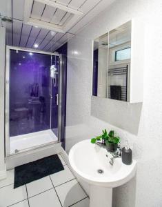 a white bathroom with a sink and a shower at Ashford House - By Sigma Stays in Etruria