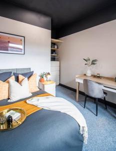 a bedroom with a bed with a desk and a desk at Ashford House - By Sigma Stays in Etruria