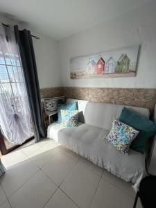 a living room with a couch and a window at Sun Beach 89 in Caleta De Fuste