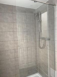a bathroom with a shower with a glass door at Westbourne Place Rooms - by Clifton Short Lets in Bristol