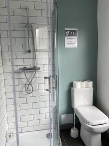 a bathroom with a toilet and a shower at Westbourne Place Rooms - by Clifton Short Lets in Bristol