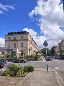 a street with a building and cars on the road at 12 Bed Clifton Townhouse in Bristol