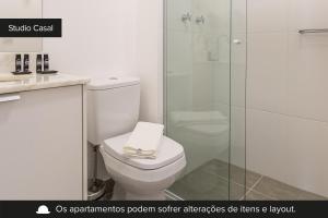 a bathroom with a toilet and a glass shower at Smart Charlie Parque Augusta Mackenzie in São Paulo
