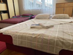 two beds in a bedroom with towels on them at Stan na dan Boljevac in Boljevac