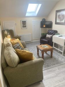 a living room with a couch and a table at Alma’s retreat in Drogheda