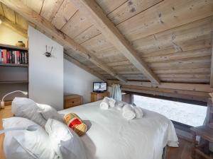 a large white bed in a room with wooden ceilings at Appartement Saint-Martin-de-Belleville, 2 pièces, 4 personnes - FR-1-570-28 in Saint-Martin-de-Belleville