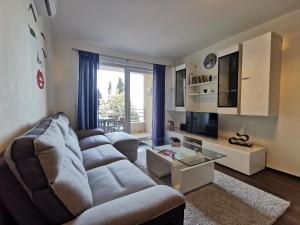 a living room with a couch and a tv at Apartment Zara in Dubrovnik
