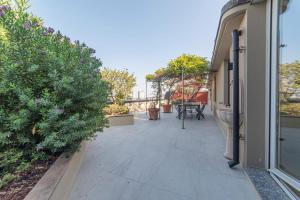 a patio with plants and a table on a building at Home 12 in Milan